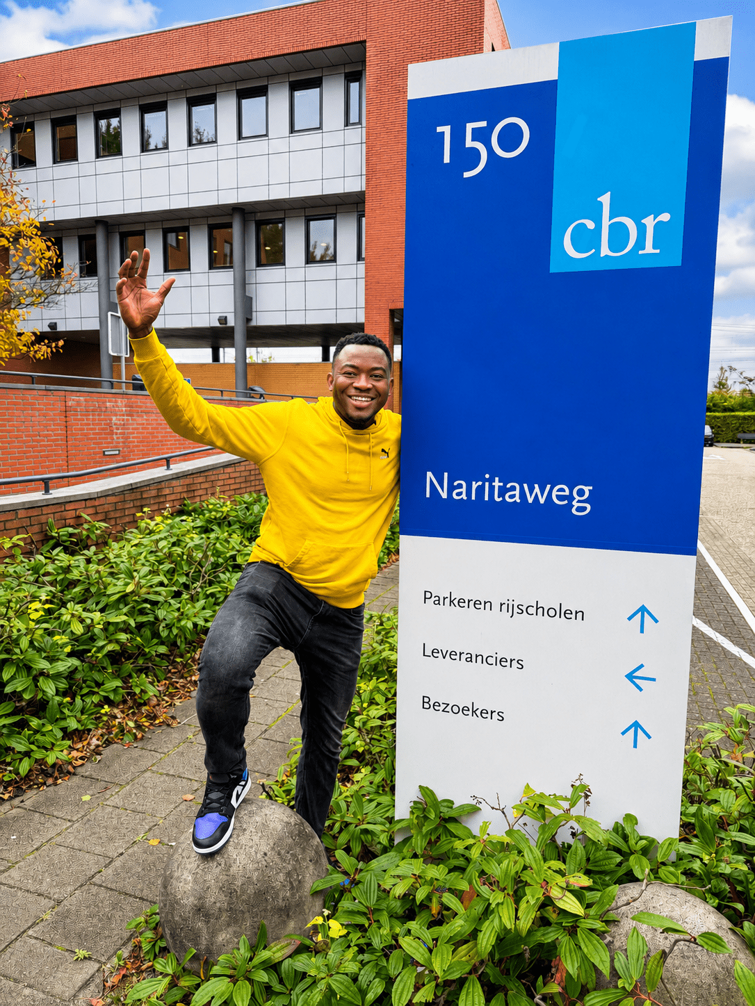 Student celebrating outside the CBR building after passing the car theory exam